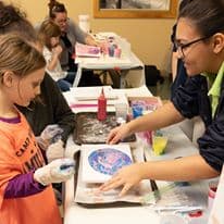Kids painting at day camp family vacation