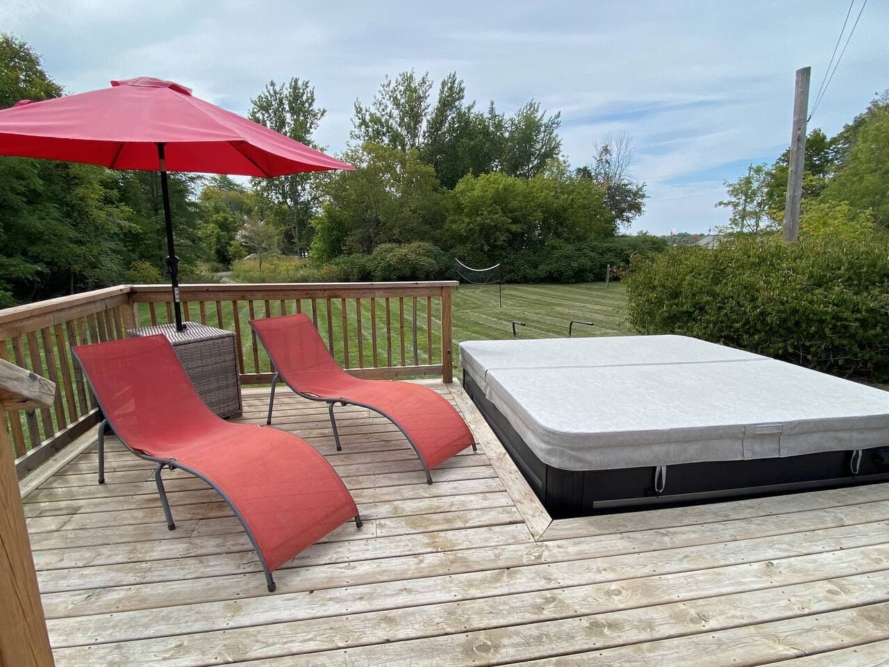 Lower deck with loungers and Hot Tub. Overlooking the large back yard area.