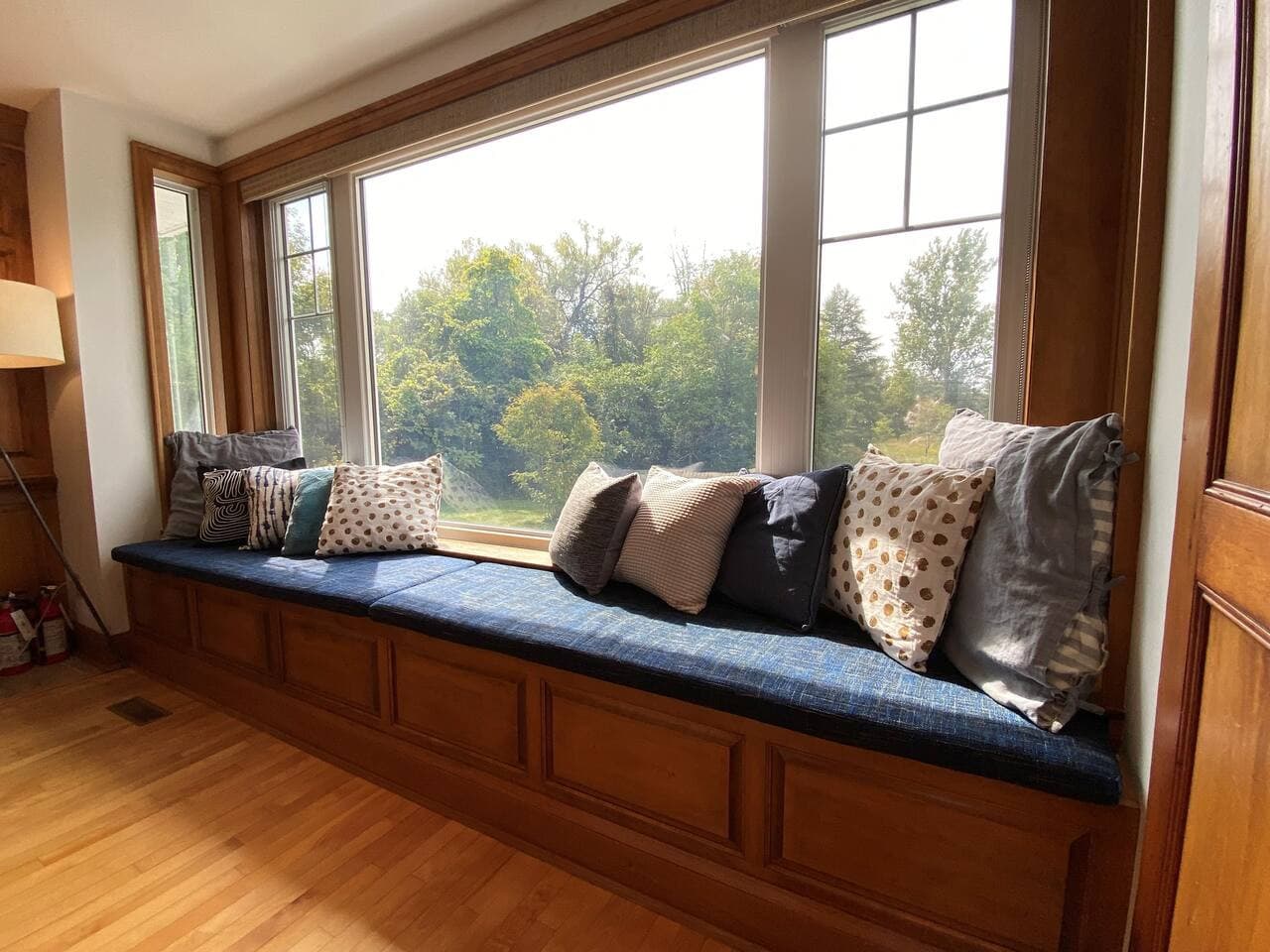 Formal living room window seat, wood fireplace, lots of comfortable seating. Main level in open concept living/dining/kitchen area.