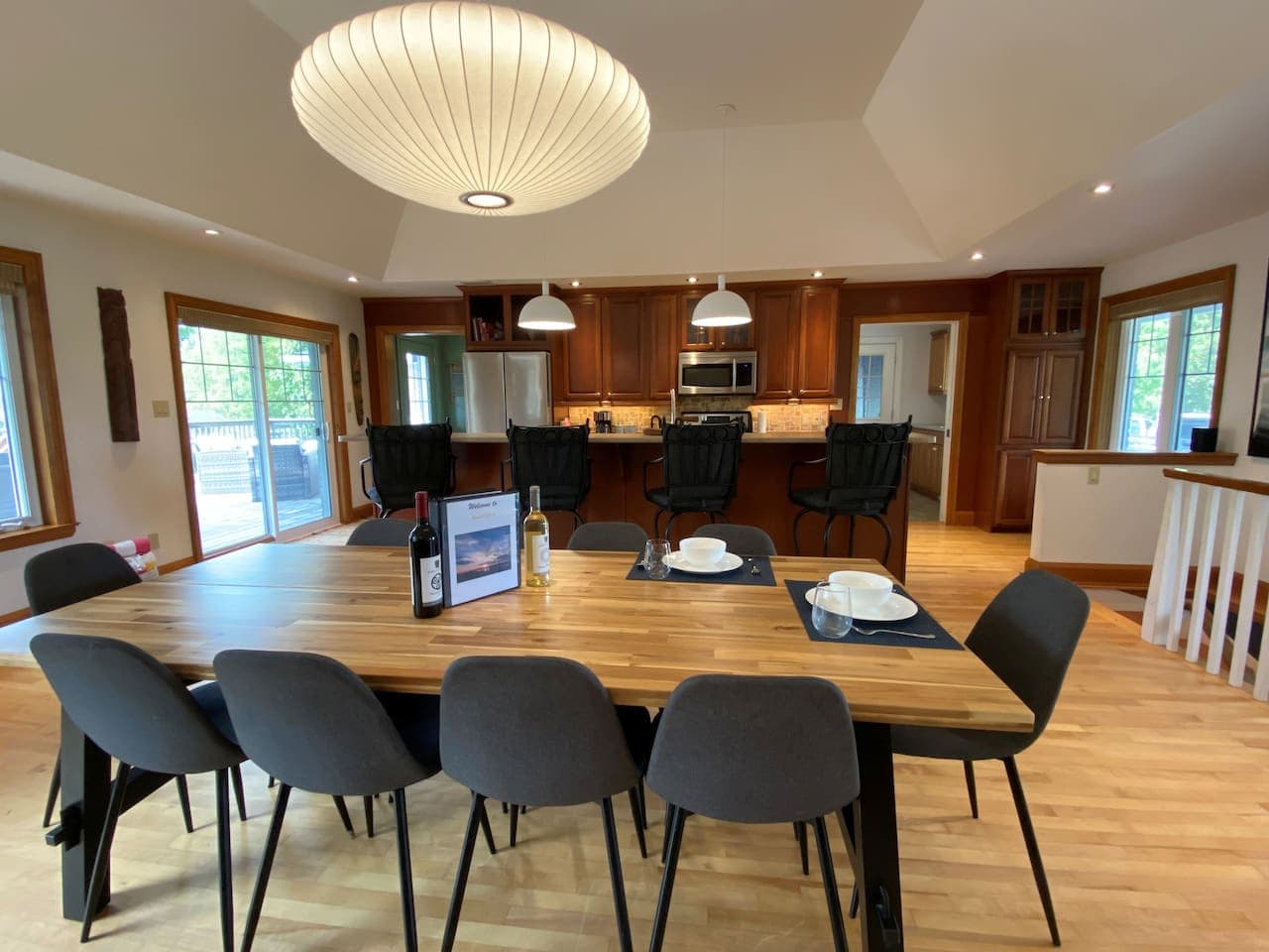 Large dining table in open concept living/dining/kitchen area. Seats up to 10