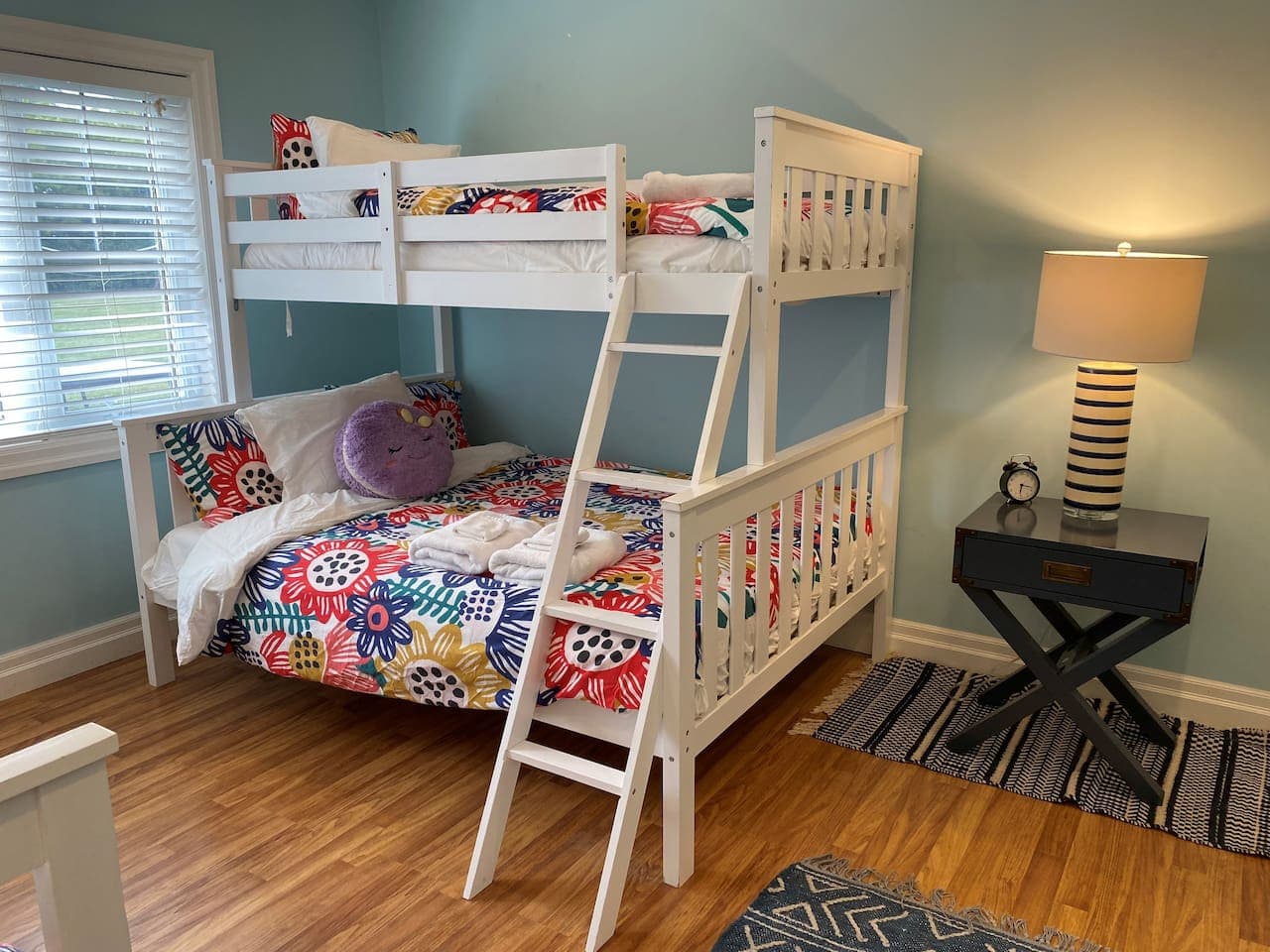Lower Level. Bedroom #4 with two single-over-double bunk bed sets. Closet, wardrobe, and lots of windows.