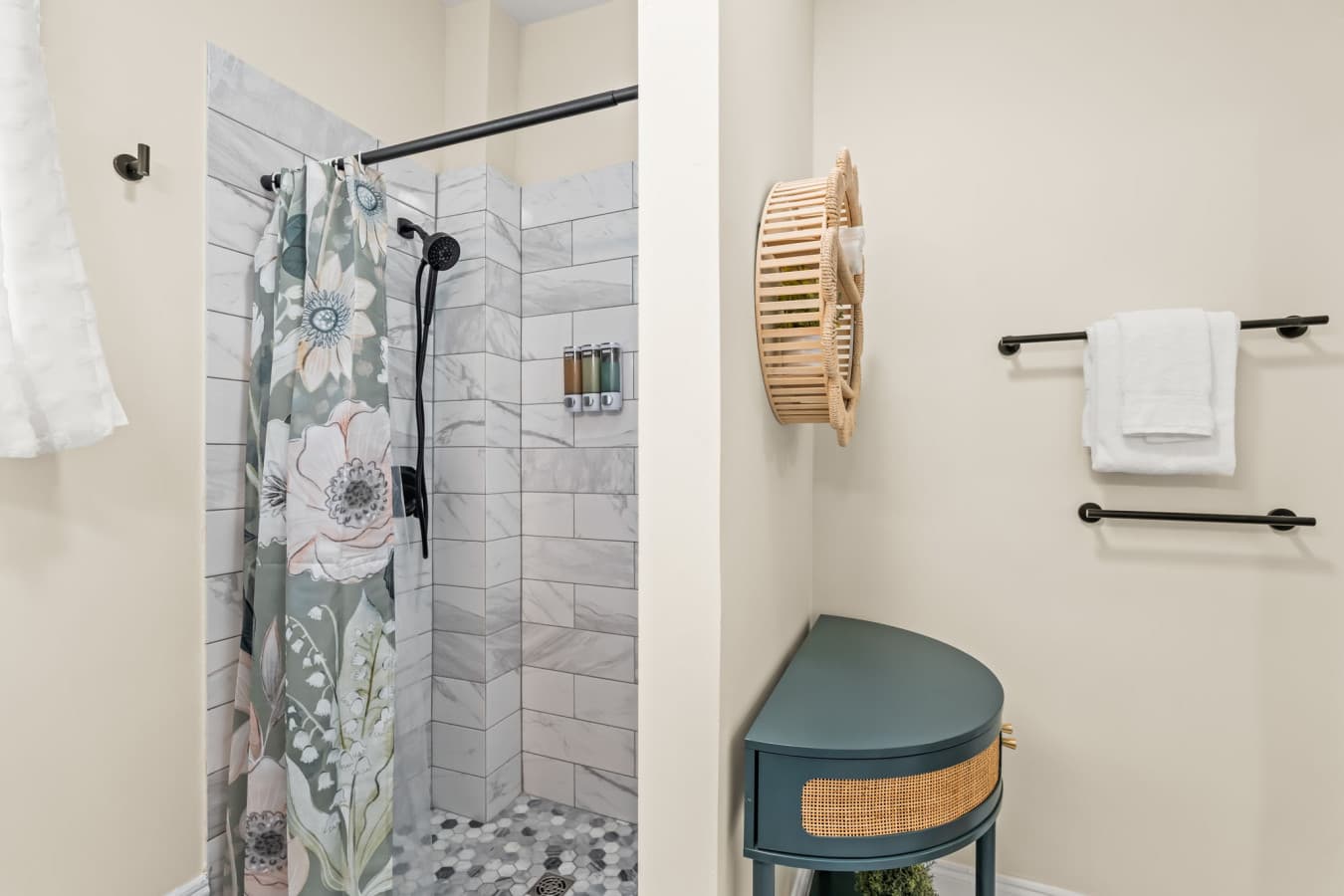 Clean, bright bathroom w/ tiled shower, soft accents, & a simple layout that feels fresh and easy to use.