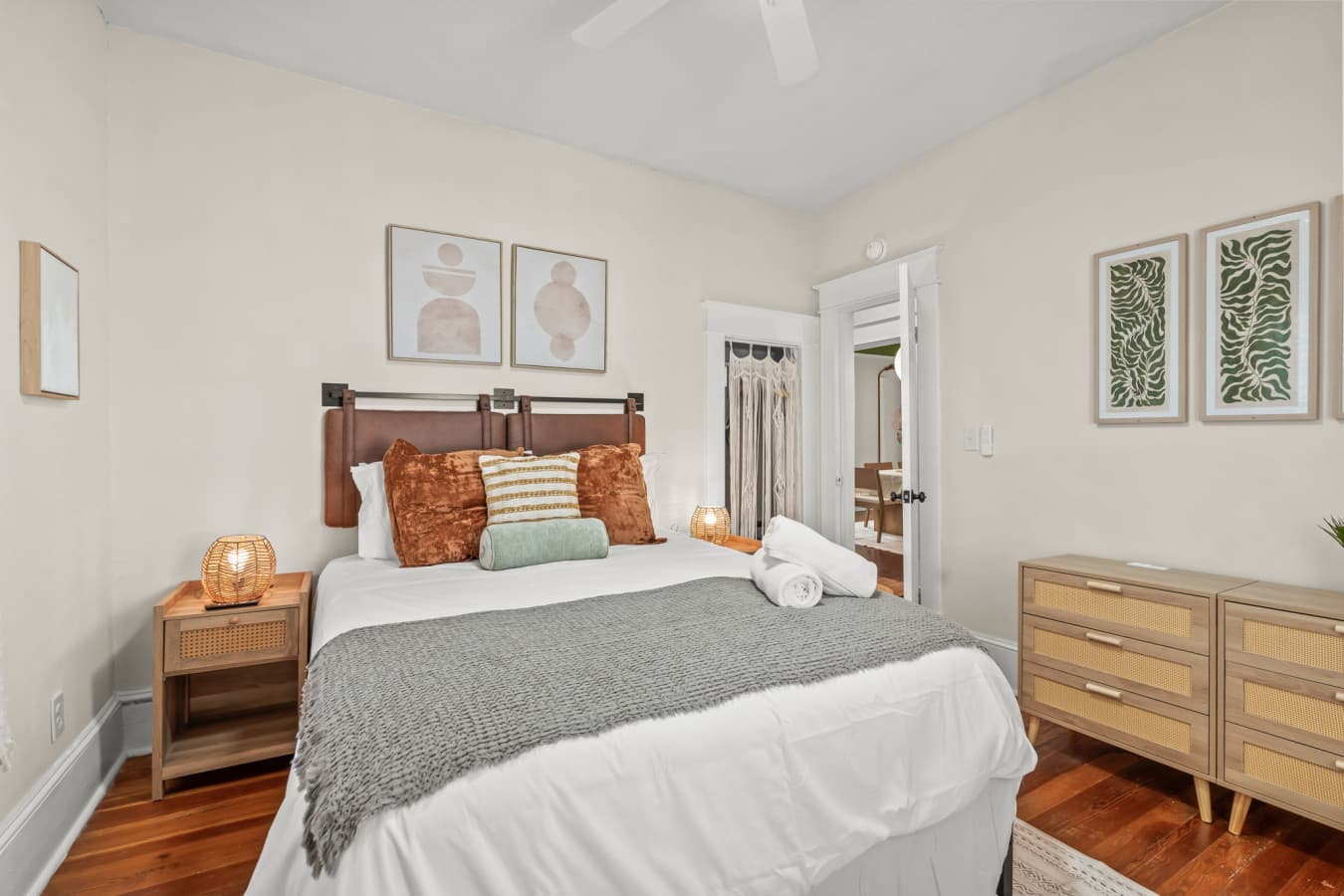 Comfortable bedroom w/ cozy bedding, warm wood tones, & a calm space for restful nights.