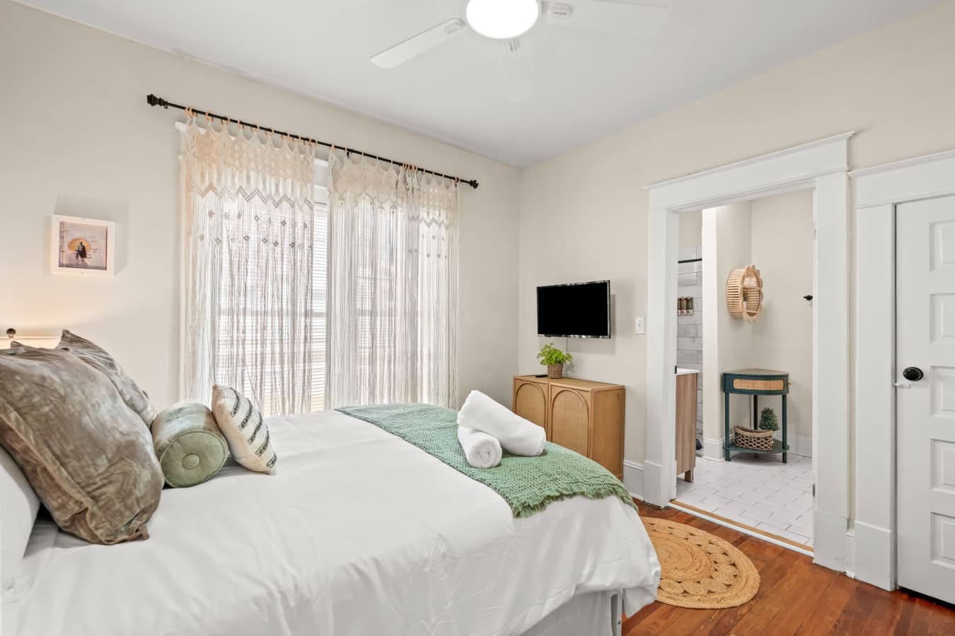 Serene bedroom retreat w/ cozy linens, gentle light, & a peaceful vibe for restful nights.