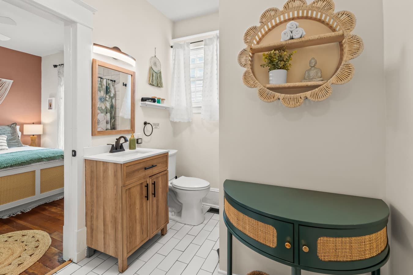 Clean vanity area w/ warm wood tones, simple decor, & a fresh, functional layout.