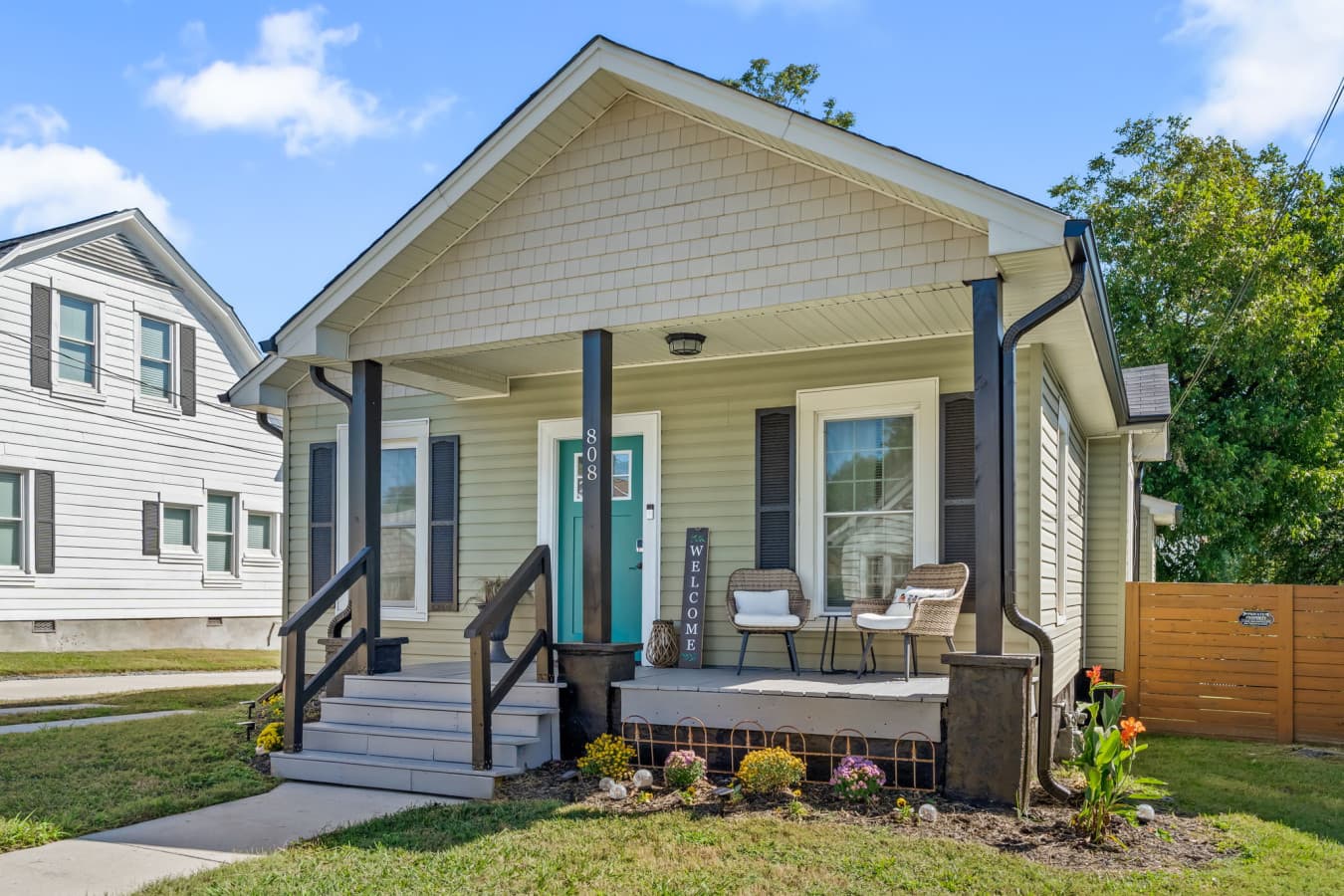Inviting front porch w/ seating, shade, & a welcoming place to enjoy fresh air.