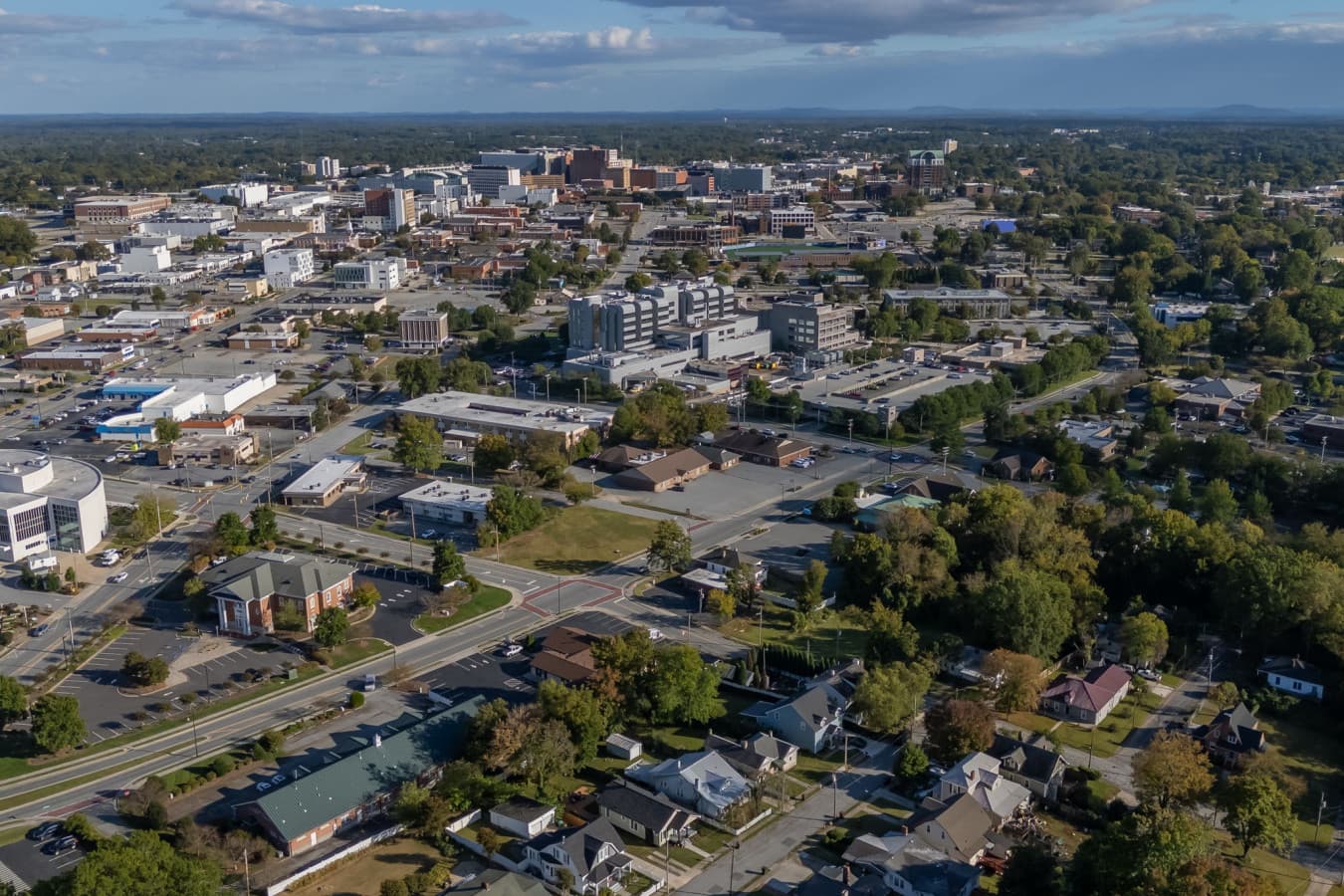 Elevated aerial view capturing the broader neighborhood & tree-lined streets.