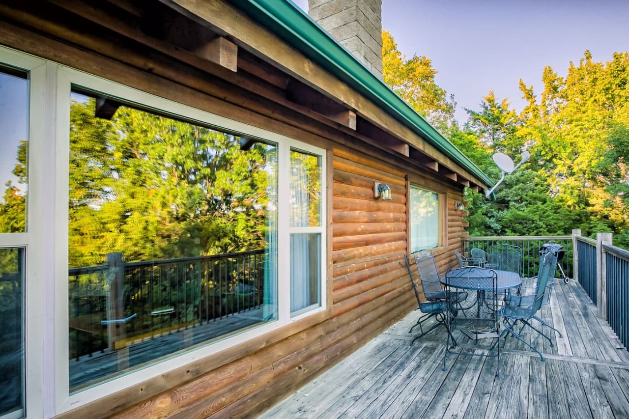 Upper deck with chairs and table. Faces lake.