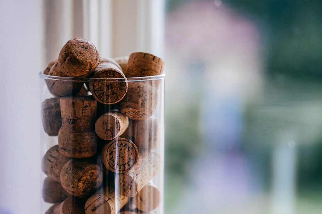A glass vase full of wine corks makes for a great interactive guest book.
